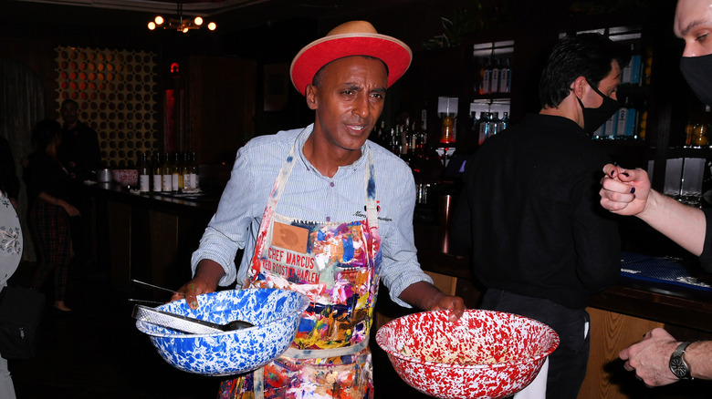 Samuelsson carrying colorful food bowls