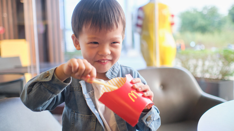 Little boy eating McDonald's fries