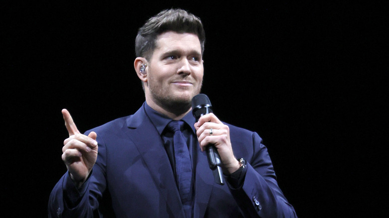 Michael Buble pointing his finger in the air on stage