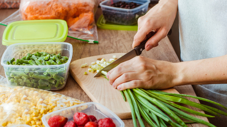 Chopping vegetables on cutting board