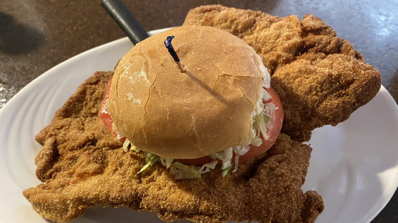 Massive pork tenderloin sandwich on tiny bun