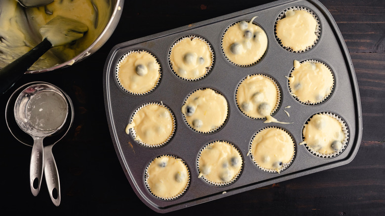 Muffin cups filled with batter