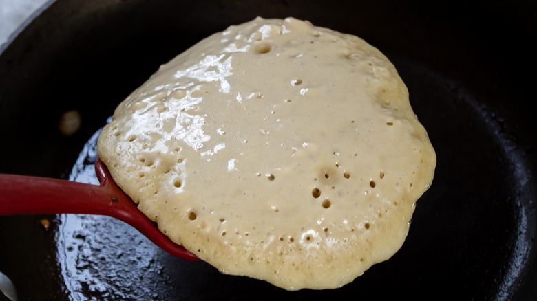 Flipping a pancake with bubbles