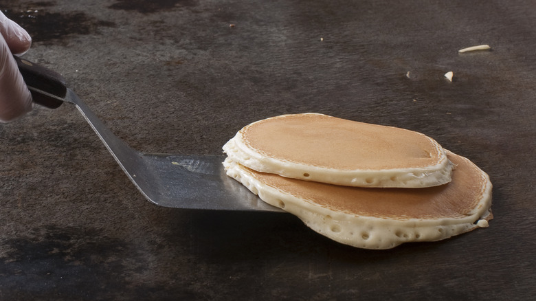 Pancakes on spatula from griddle