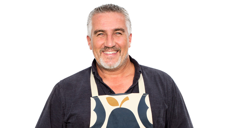 Paul Hollywood wears an apron