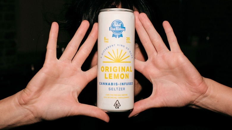 Hands holding PBR cannabis seltzer