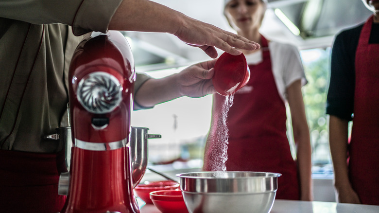 Adding ingredients to mixing bowl