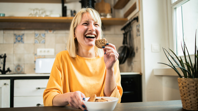 Woman eating a biscuit