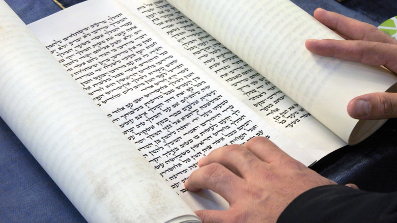 A rabbi opening a scroll