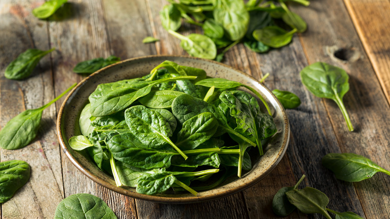 spinach salad in rustic bowl