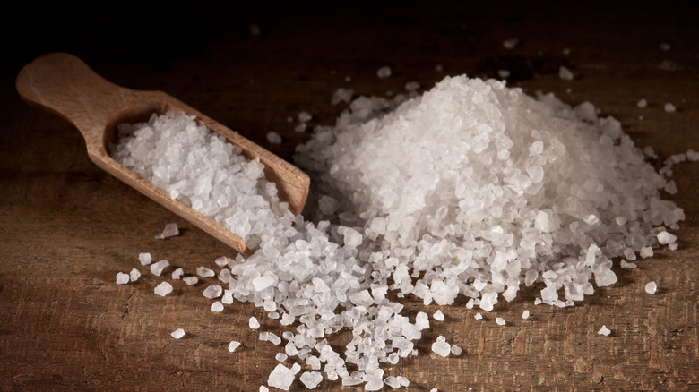 pile of sea salt and wooden scoop