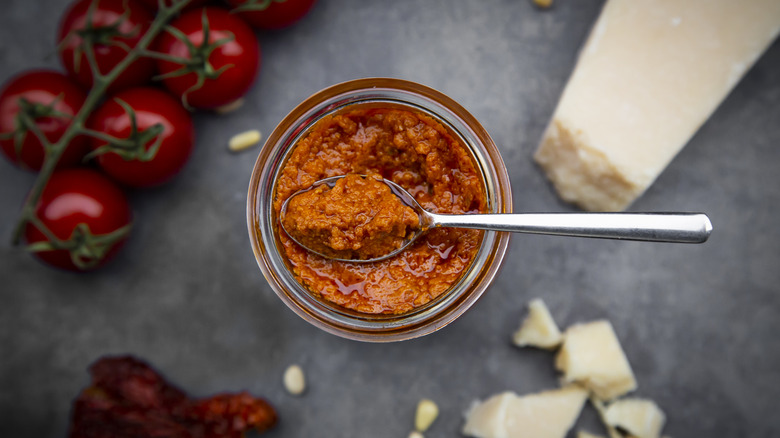 red pesto in bowl with tomatoes