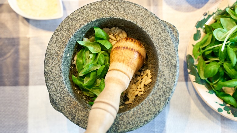 pesto being made in mortar and pestle