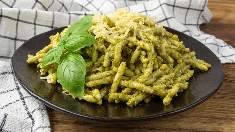 trofie pasta and pesto on black plate