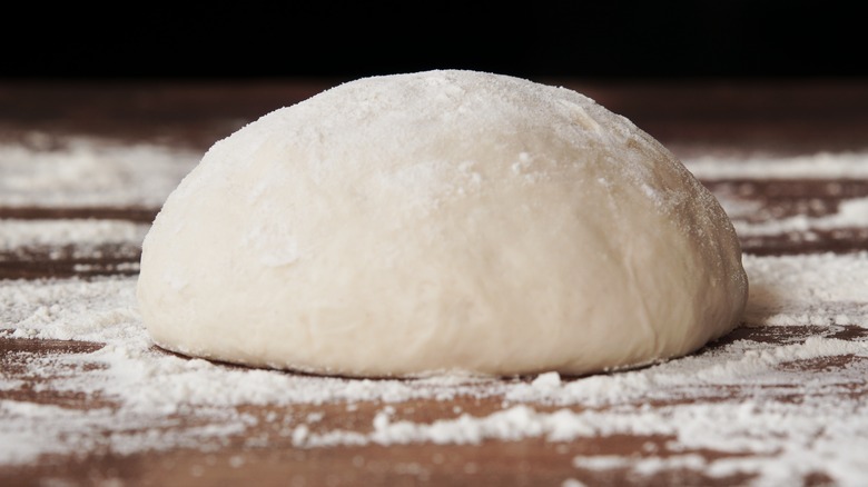 dough ball rising with flour 