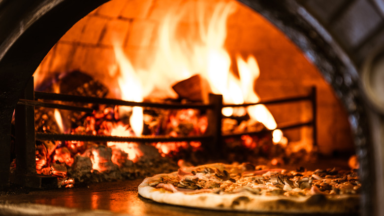 brick-oven with pizza and fire 