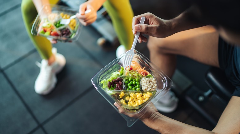 eating healthy meal wearing workout clothes