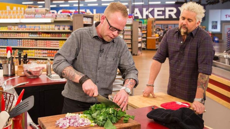 Guy Fieri and a chef on Guy's Grocery Games