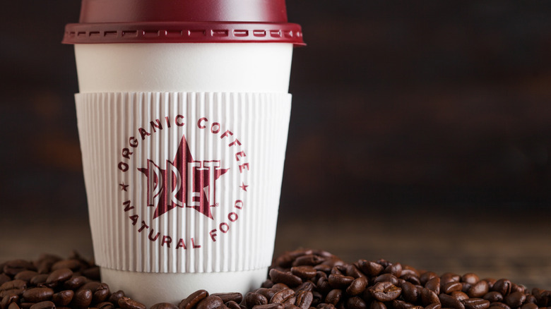 hot beverage cup from Pret-a-Manger with cardboard sleeve and lid