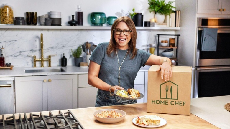 Rachael Ray posing with Home Chef box in kitchen 
