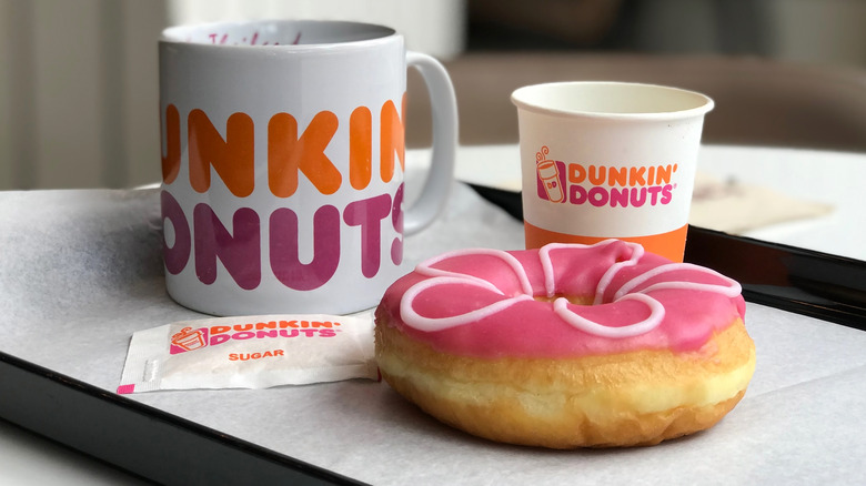 Dunking donuts coffee and pink frosted donut