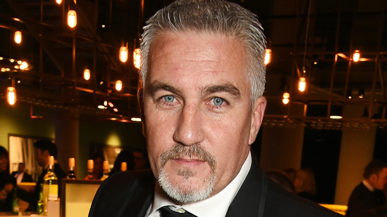 Close-up of Paul Hollywood wearing a black suit and tie