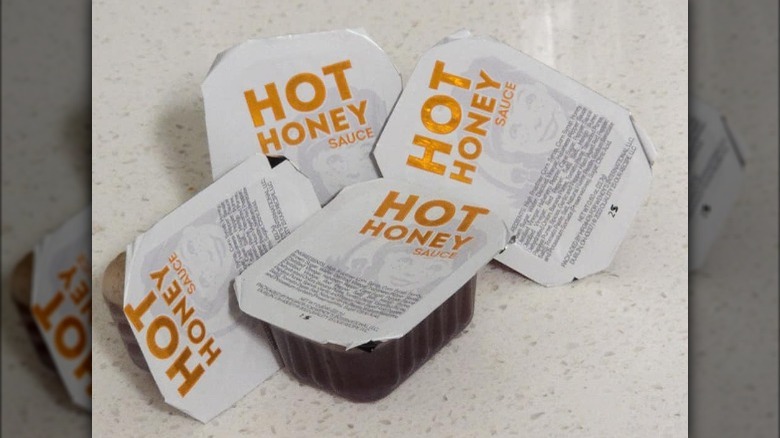 Several packs of Wendy's hot honey sauce