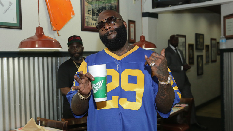 Rick Ross posing at Wingstop