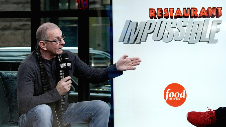 Robert Irvine speaks near restaurant: Impossible logo