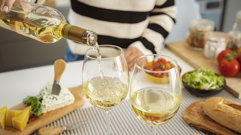 Woman pouring white wine