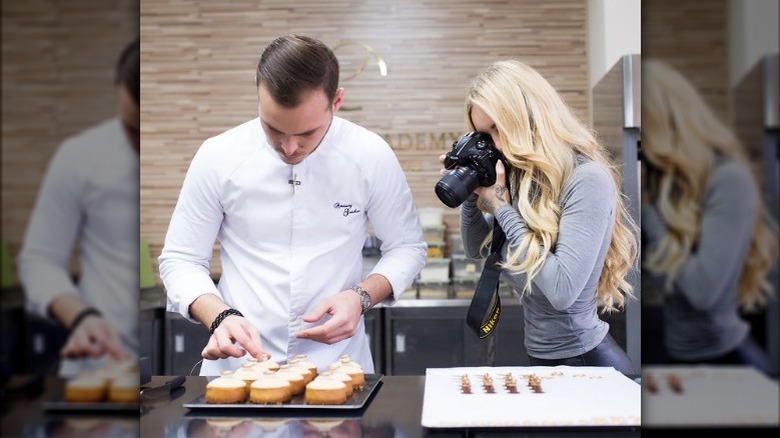 Fiona Guichon taking a picture of Amaury Guichon's desserts