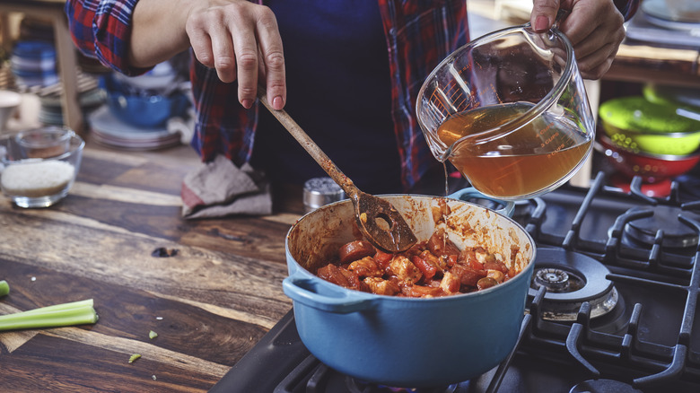 Person cooking seafood stew