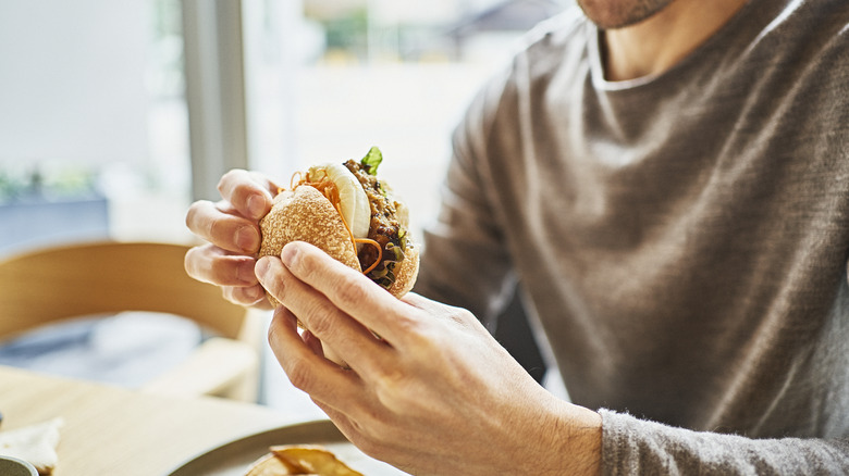 Man eating vegan burger