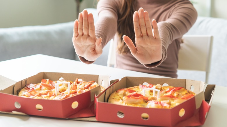 Girl refusing pizza