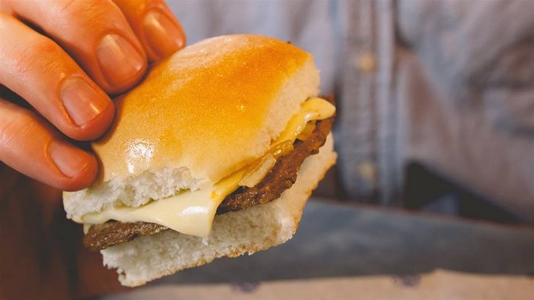 Hand holding fast food slider