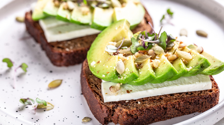 Two slices of avocado toast on rye