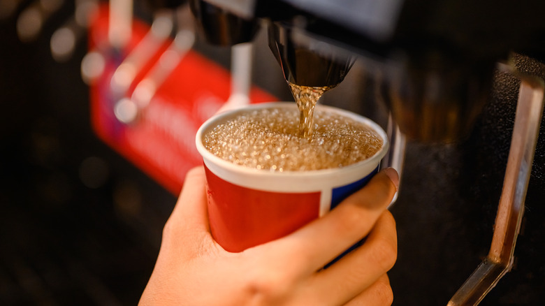 Soda pouring into cup from fountain