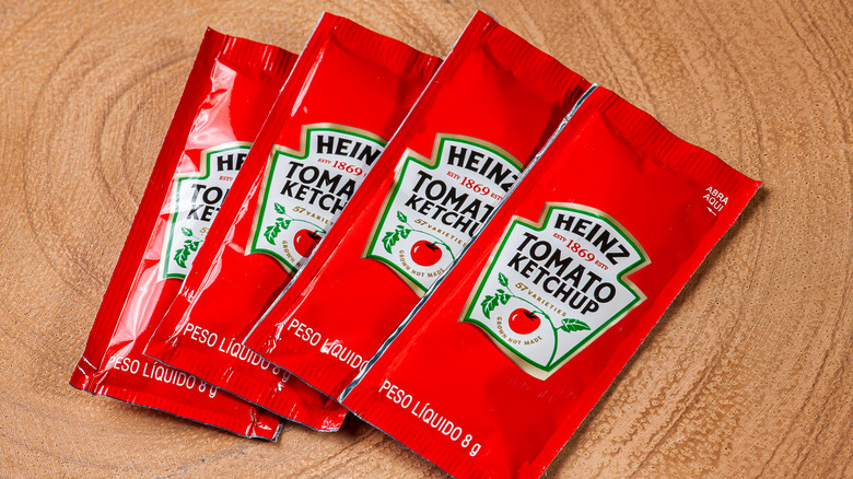 close up of packets of heinz tomato ketchup