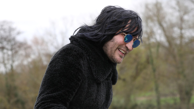 Noel Fielding playing around outside