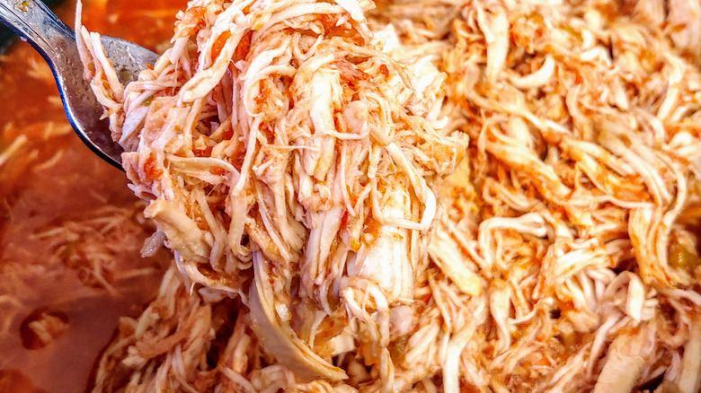 shredded chicken in bowl with salsa