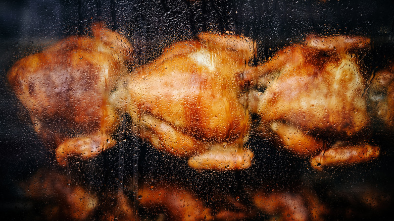 rotisserie oven pane with chickens on a spit