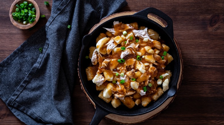 Tater Tots topped with chicken, cheese curds, gravy, and onions