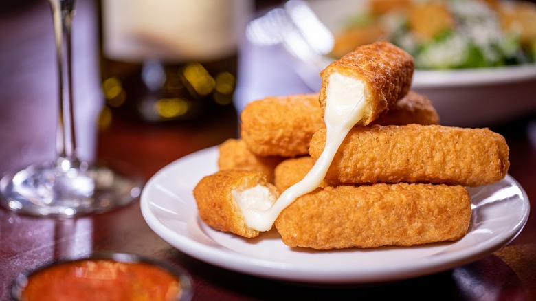 fried mozzarella sticks on plate