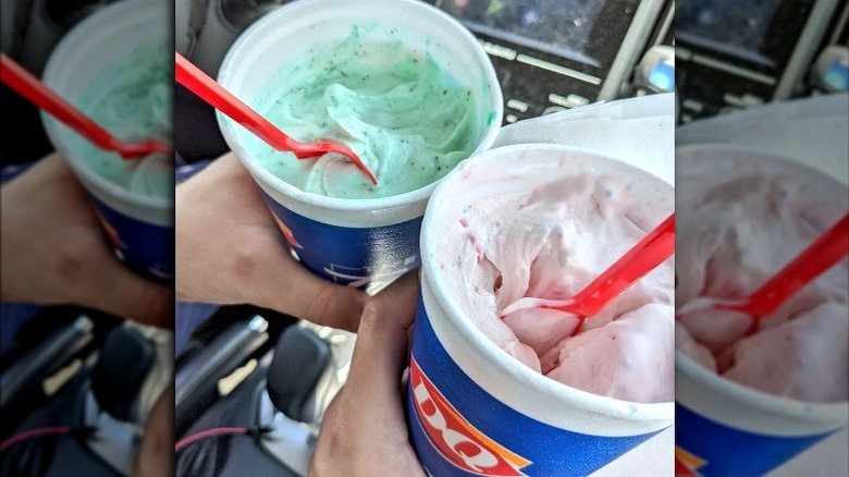 Hands holding cups of Dairy Queen Blizzards