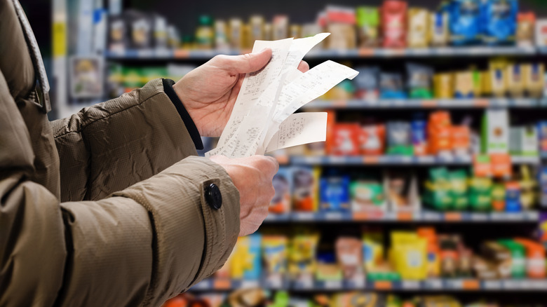 Person looking at receipts in store