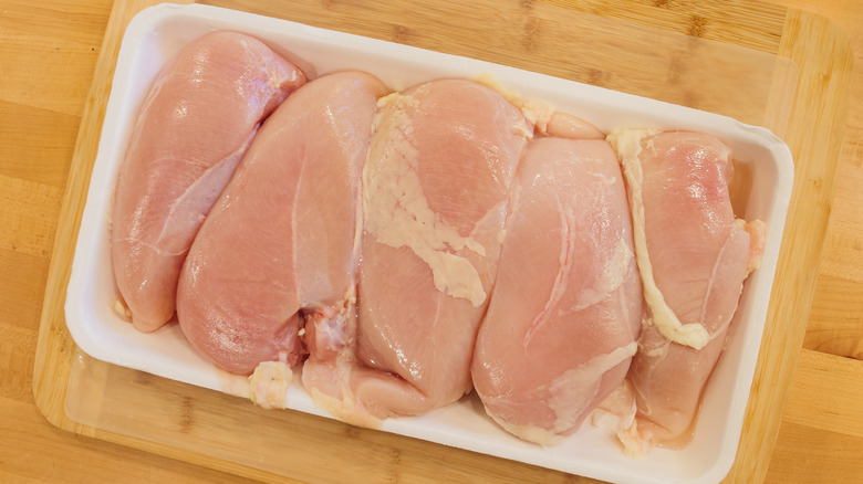 Package of five raw chicken breasts