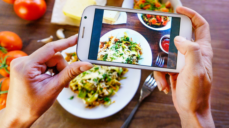 Hands taking Instagram food photo