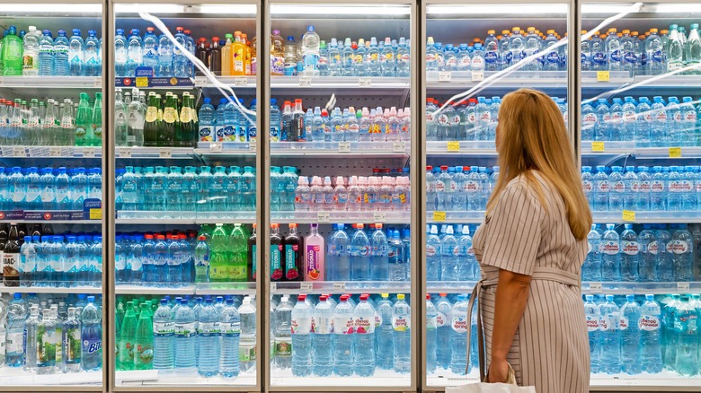 woman perusing bottled water section