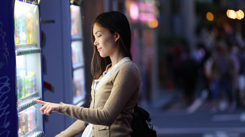 Japanese woman using vending machine