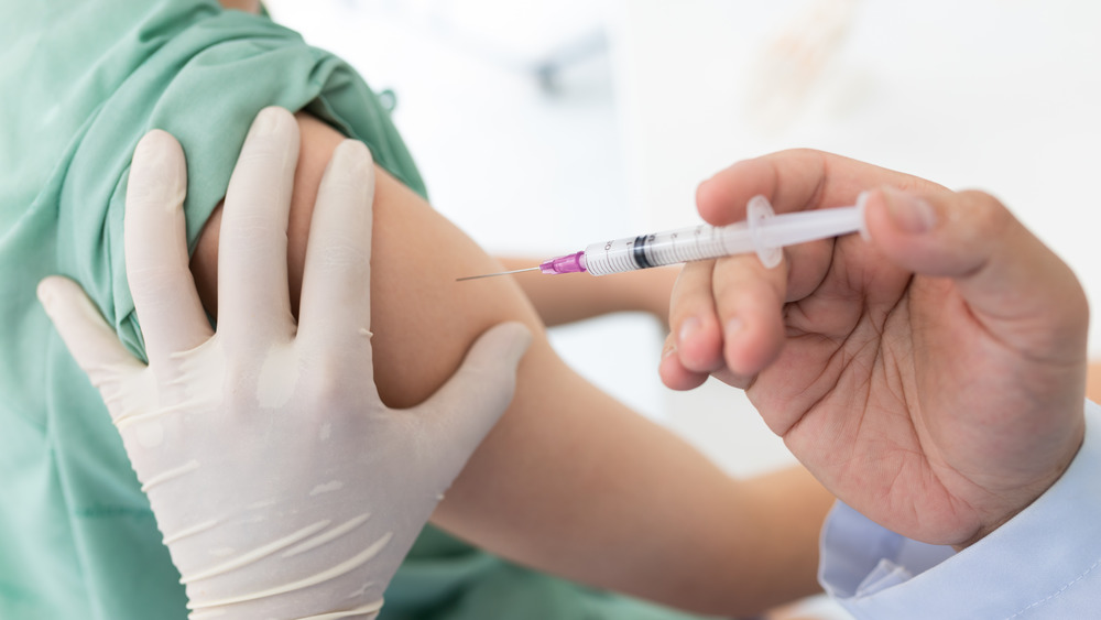 Health care worker giving someone a vaccination in the arm